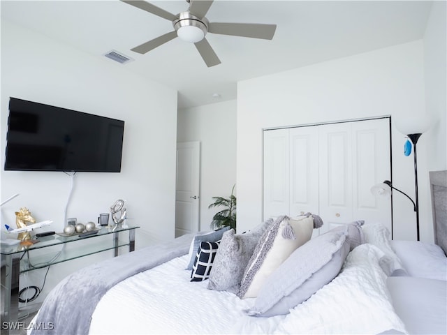 bedroom with ceiling fan and a closet