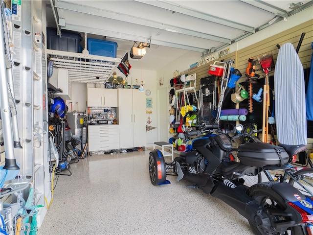 garage featuring a garage door opener and water heater