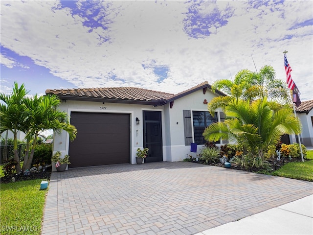 mediterranean / spanish-style house with a garage