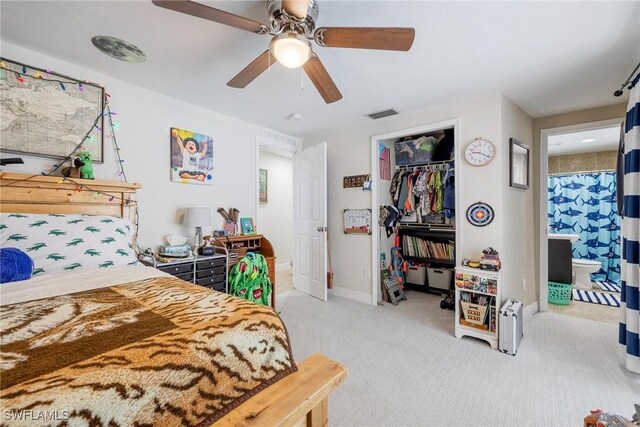 bedroom featuring ceiling fan, light colored carpet, connected bathroom, and a closet