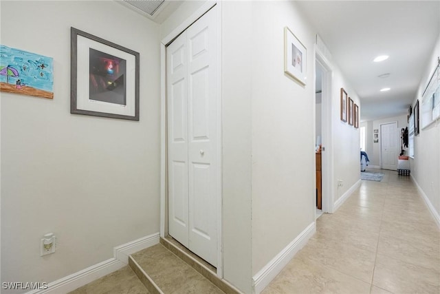 hall featuring light tile patterned floors