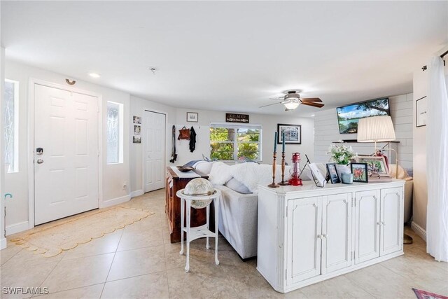 tiled living room featuring ceiling fan