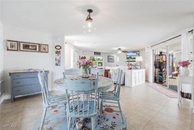 dining area with ceiling fan and light tile patterned floors