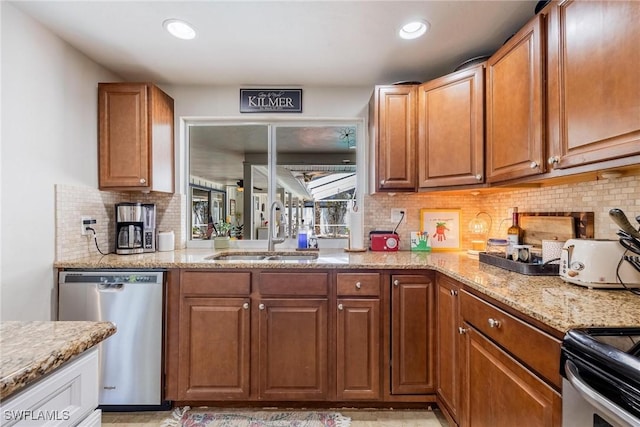 kitchen with backsplash, dishwasher, range, light stone counters, and sink