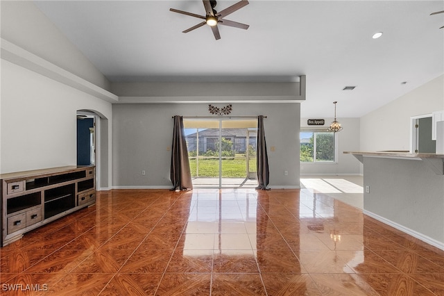 unfurnished living room with tile patterned floors, ceiling fan, and vaulted ceiling