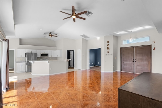 unfurnished living room featuring ceiling fan, light tile patterned flooring, and high vaulted ceiling