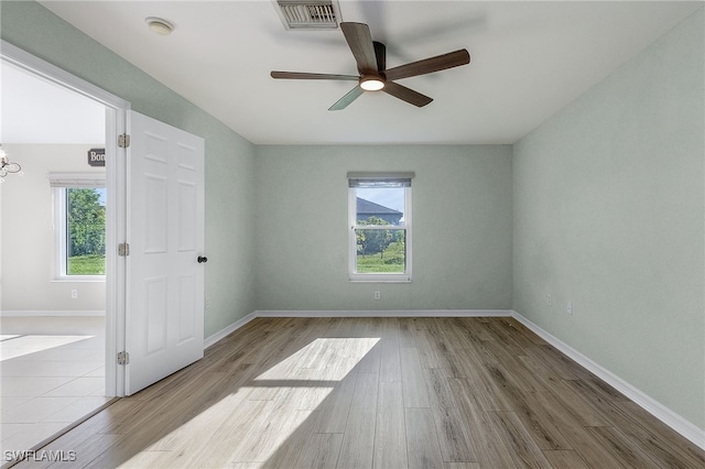 empty room featuring ceiling fan and light hardwood / wood-style floors