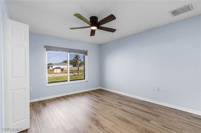 spare room featuring light hardwood / wood-style floors and ceiling fan