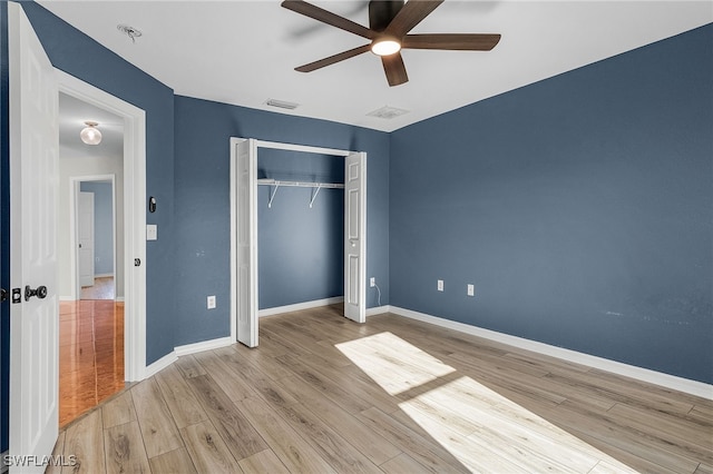 unfurnished bedroom with ceiling fan, a closet, and light hardwood / wood-style floors