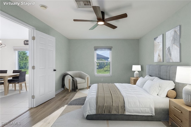 bedroom with light hardwood / wood-style floors and ceiling fan