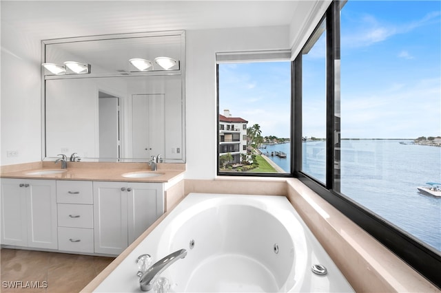 bathroom with a water view, hardwood / wood-style floors, a bath, and vanity