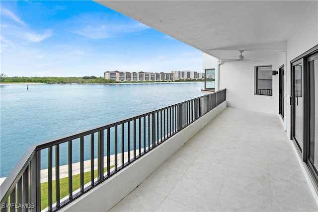 balcony with a water view and ceiling fan