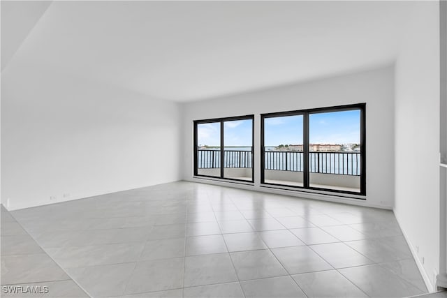 spare room featuring light tile patterned floors