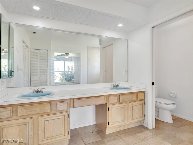 bathroom featuring ceiling fan, vanity, and toilet