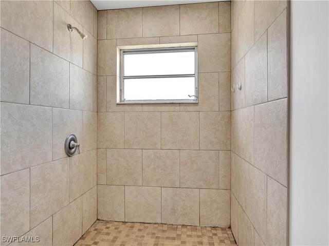 bathroom with tiled shower