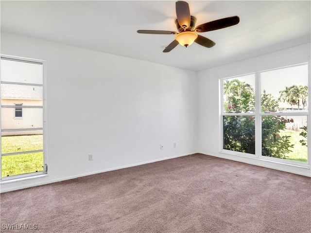 empty room with carpet, plenty of natural light, and ceiling fan