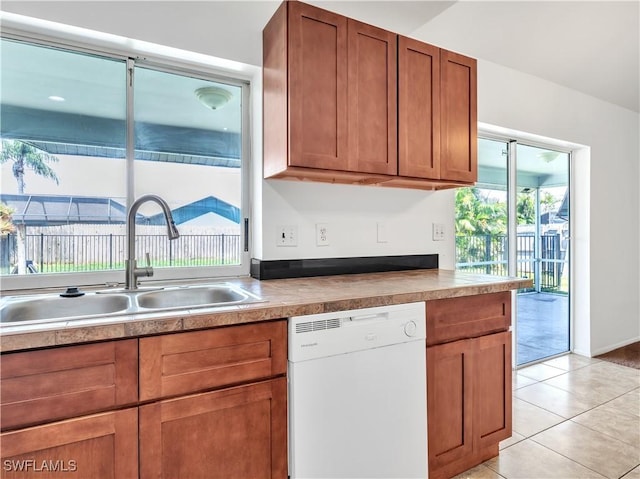 kitchen featuring dishwasher, light tile patterned flooring, and sink