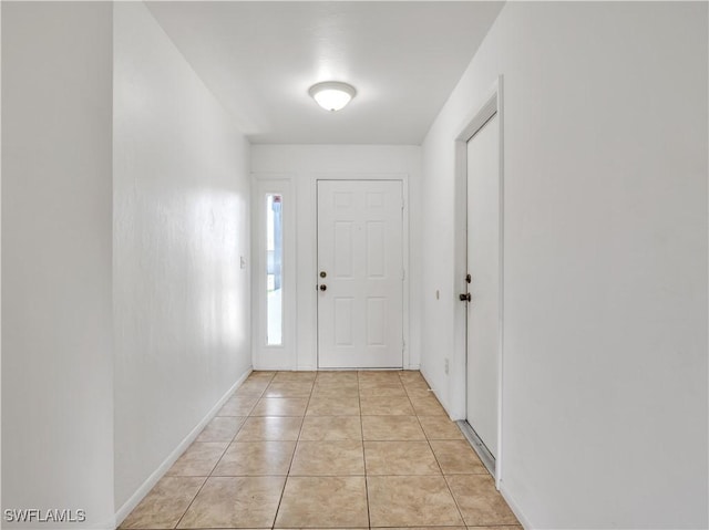 doorway featuring light tile patterned flooring