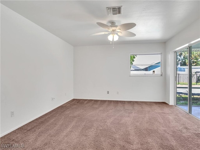 unfurnished room featuring ceiling fan and carpet floors