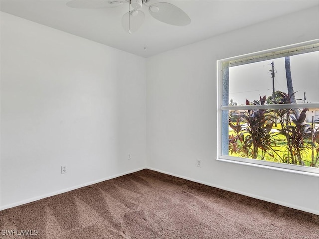 carpeted spare room with ceiling fan