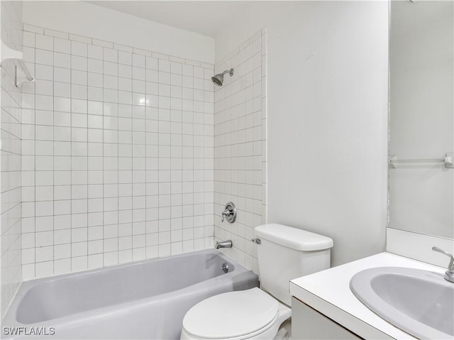 full bathroom featuring vanity, toilet, and tiled shower / bath