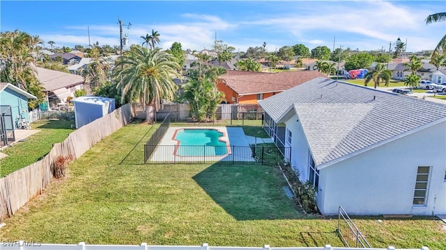 view of pool with a yard