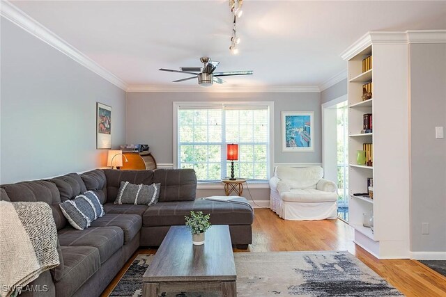 living room featuring ceiling fan, track lighting, crown molding, and wood-type flooring