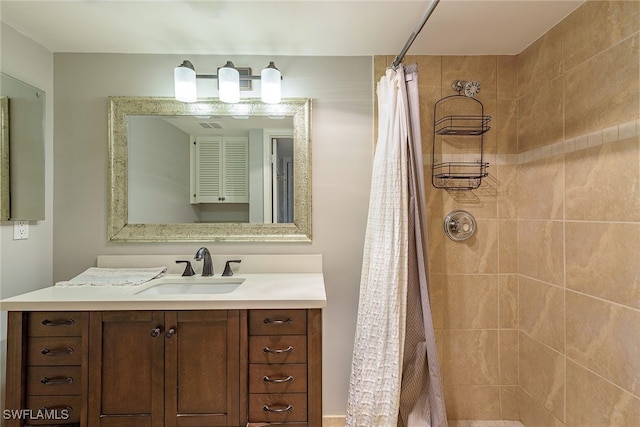 bathroom with walk in shower and vanity