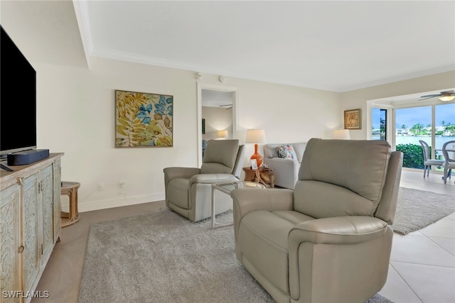 tiled living room featuring ceiling fan and crown molding