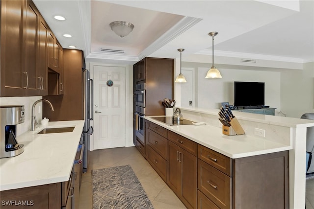 kitchen featuring decorative light fixtures, a raised ceiling, light tile patterned flooring, and sink