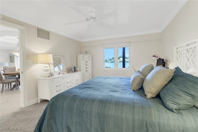 bedroom with crown molding, ceiling fan, and light colored carpet