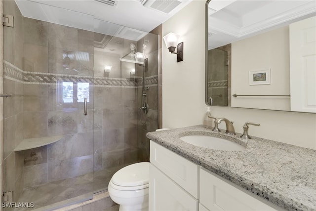 bathroom with vanity, toilet, and a shower with door