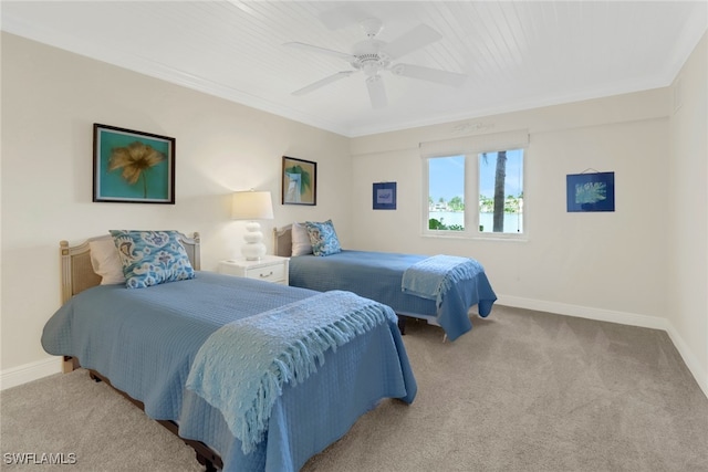 carpeted bedroom with ceiling fan and crown molding