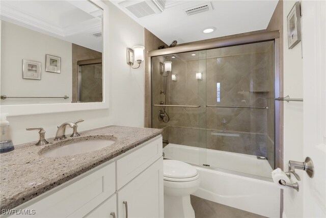 full bathroom featuring tile patterned floors, toilet, vanity, and combined bath / shower with glass door