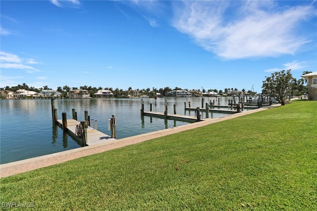 view of dock featuring a lawn and a water view