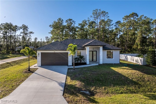 view of front of property with a front yard and a garage