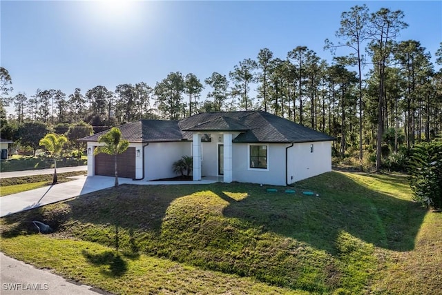 view of front of home with a garage and a front lawn