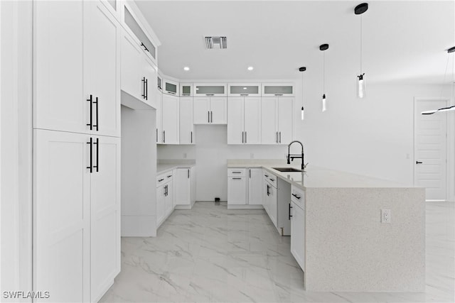 kitchen with a center island, sink, hanging light fixtures, white dishwasher, and white cabinets