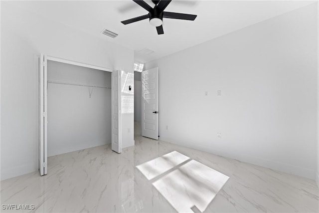 unfurnished bedroom featuring ceiling fan and a closet