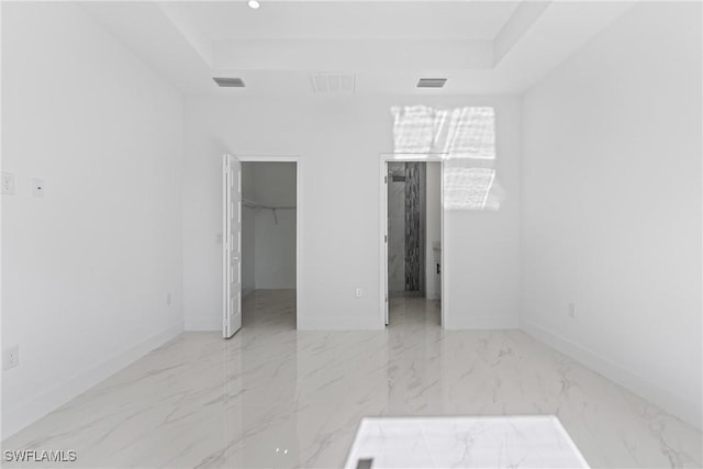 empty room featuring a raised ceiling