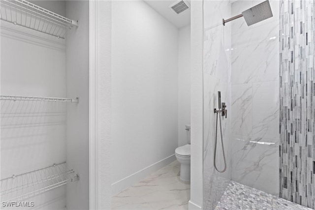 bathroom with tiled shower and toilet