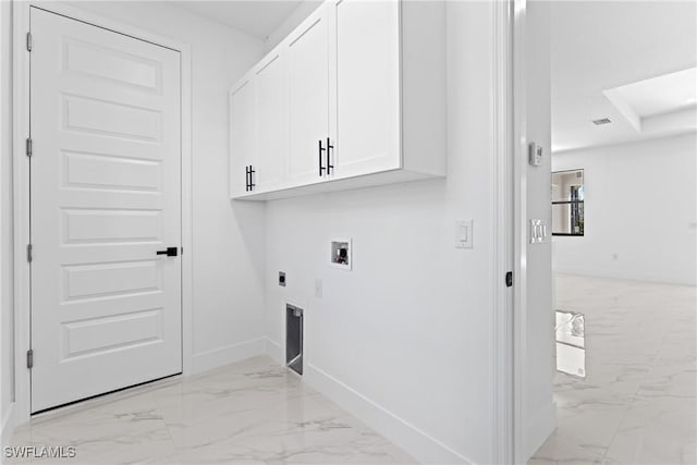 clothes washing area with electric dryer hookup, cabinets, and washer hookup