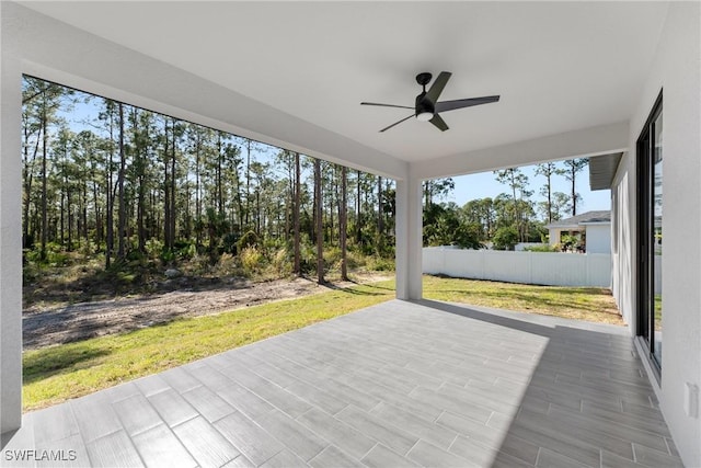 unfurnished sunroom with ceiling fan