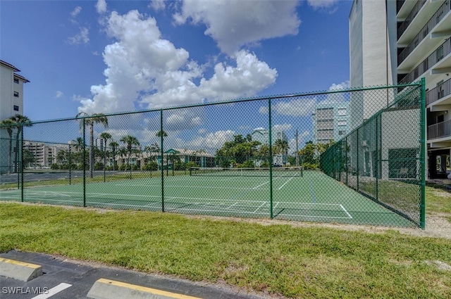 view of sport court featuring a yard