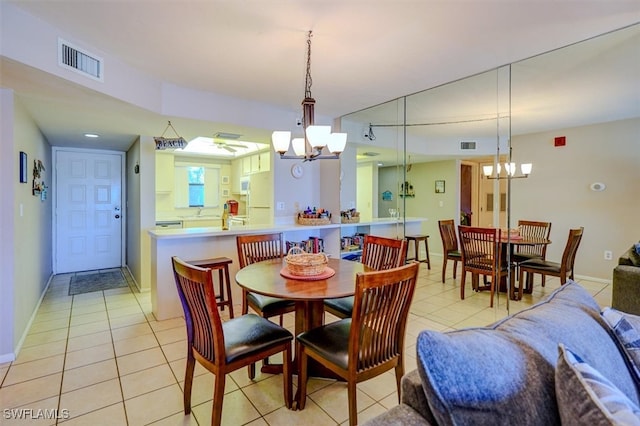 tiled dining area with an inviting chandelier