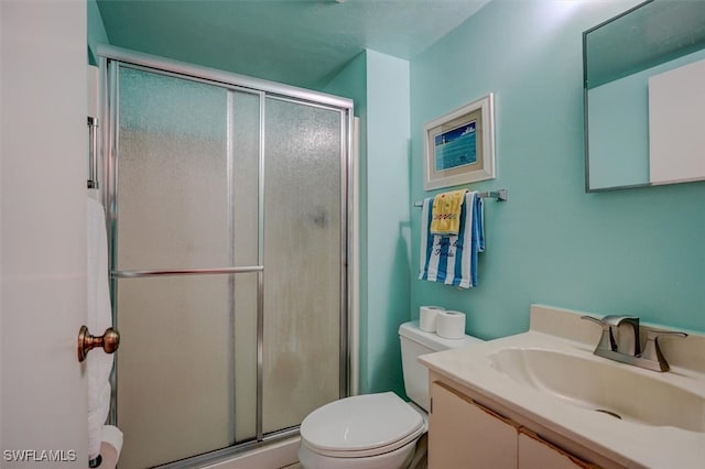 bathroom featuring vanity, toilet, and walk in shower