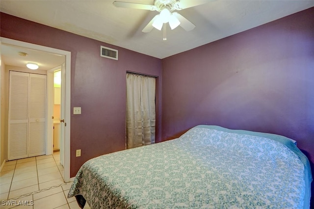 bedroom with light tile patterned flooring, ceiling fan, and a closet