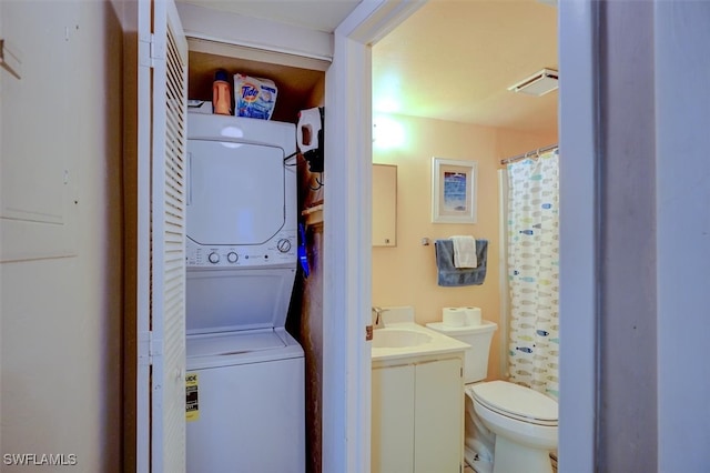 clothes washing area with stacked washer / dryer and sink