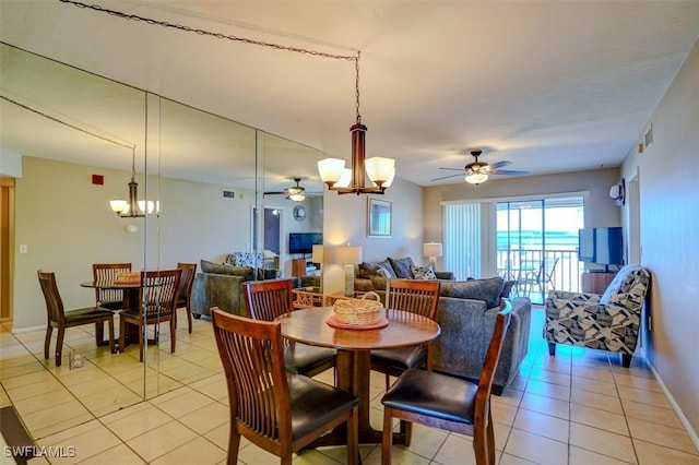 dining space featuring ceiling fan with notable chandelier and light tile patterned floors