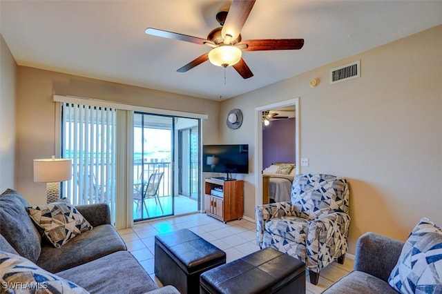 living room with ceiling fan and light tile patterned flooring